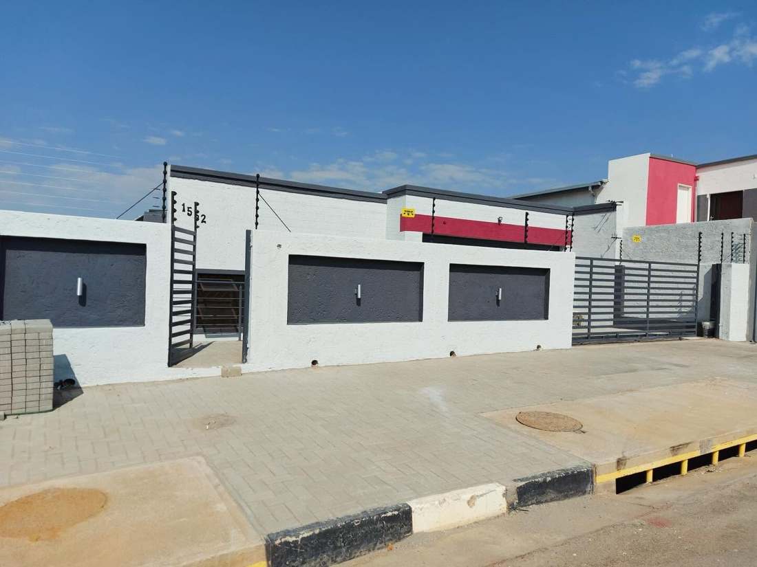Completed modern residential exterior with driveway and gate