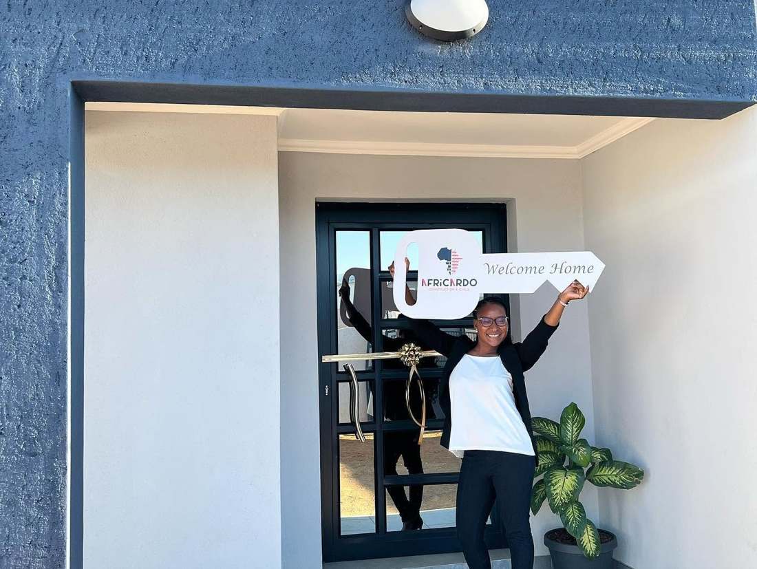 Client receiving keys at the front door of a completed Africardo home
