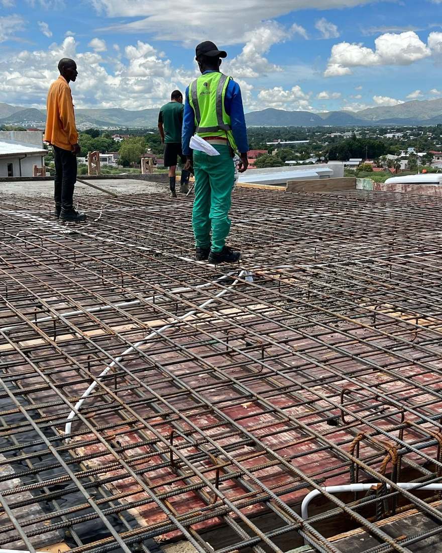 Africardo crew fixing steel reinforcement on a suspended concrete deck